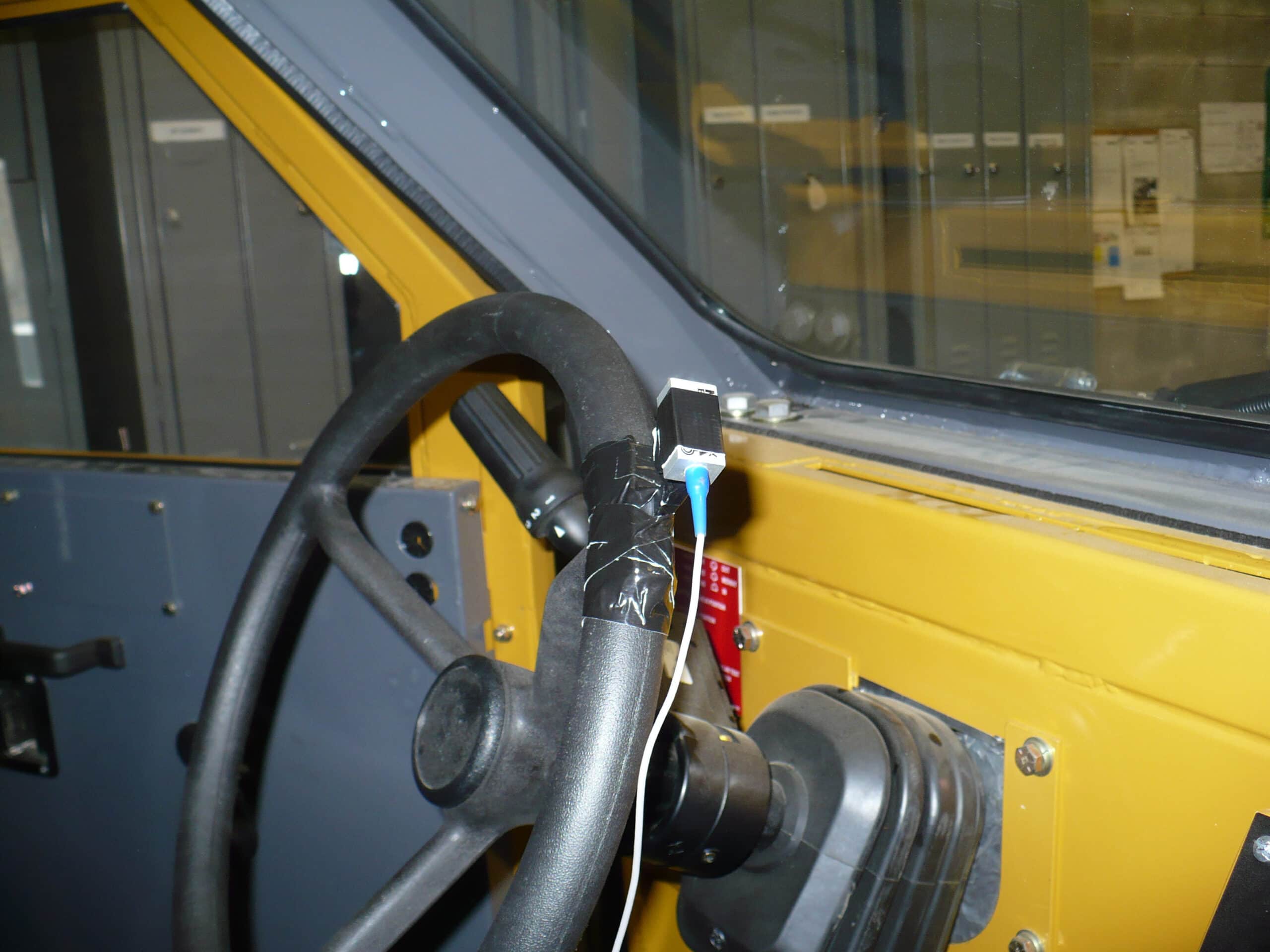 Accelerometer attached to the steering wheel on a piece of mobile equipment
