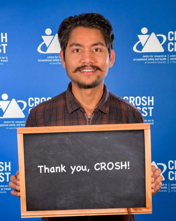 CROSH student member Pranil G C holding a sign that says, "Thank you, CROSH!"