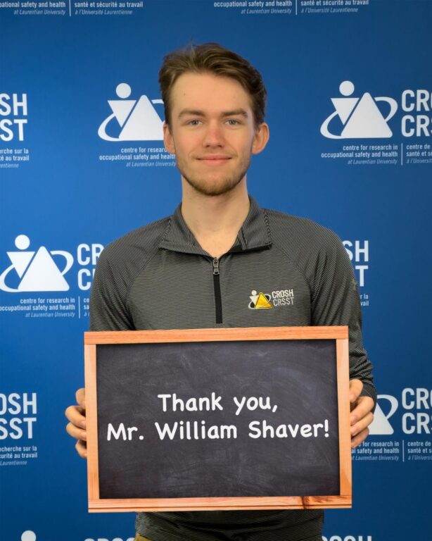 CROSH student member Dawson O'Hara holding a sign that says "Thank you, Mr. William Shaver!"