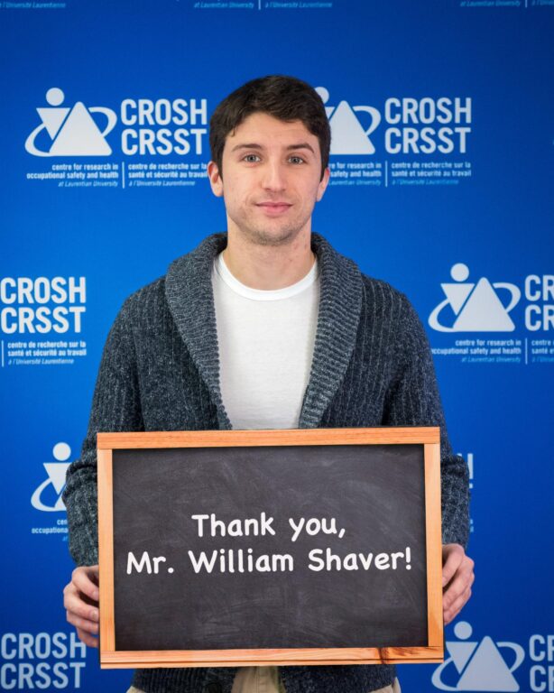 CROSH student member William Nesbitt holding a sign that says "Thank you, Mr. William Shaver!"