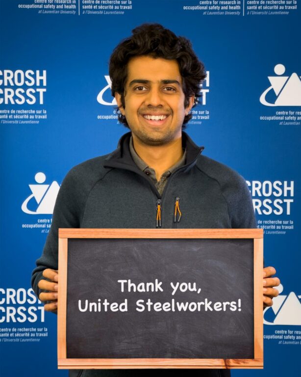 CROSH student member Shaantanu Kulkarni holding a sign that says "Thank you, United Steelworkers!"